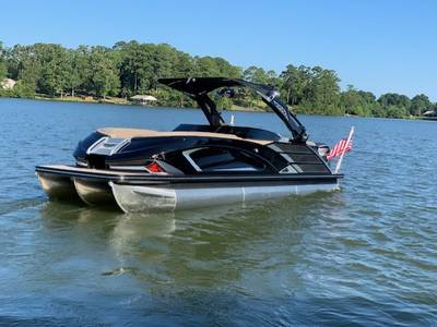 sleek black pontoon boat with an American flag