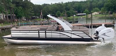 luxurious white and black pontoon boat with a Yamaha outboard motor